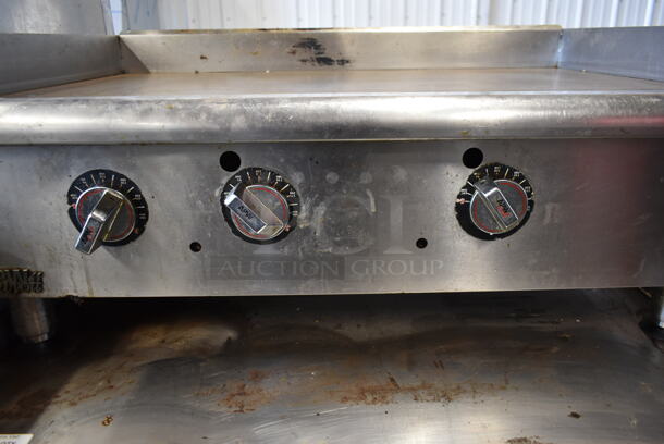 APW Wyott Stainless Steel Commercial Countertop Natural Gas Powered Flat Top Griddle.  - Image 4 of 7