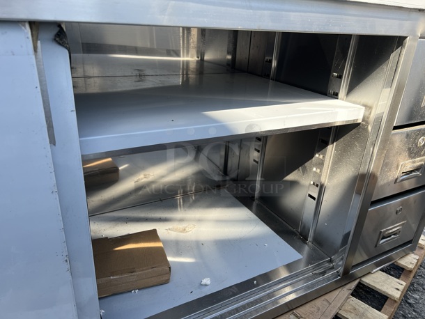 BRAND NEW SCRATCH AND DENT! Regency 600EBT2472R Stainless Steel Commercial 24" x 72" 16 Gauge Type 304 Enclosed Base Sliding Door Table with Drawers - Image 3 of 10