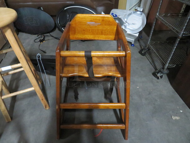 One Wooden High Chair With Safety Straps.