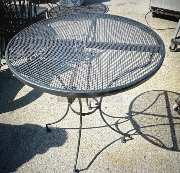 One Black Metal Round Patio Table With Umbrella Hole. 48X29 - Image 1 of 1