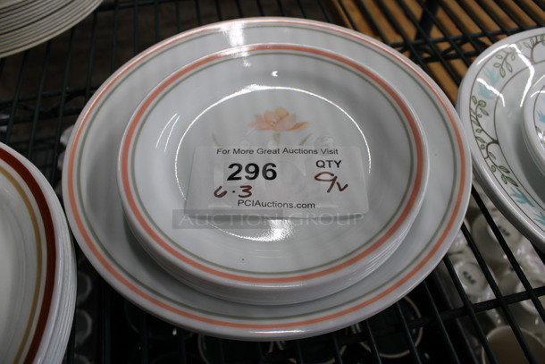 9 Various Sized White Ceramic Plates w/ Orange Line on Rim and Floral Pattern. 10.5x10.5x1, 7.5x7.5x1. 9 Times Your Bid!