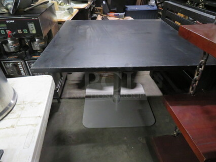 One Black Laminate Table Top On A Pedestal Base. 42X42X29.5