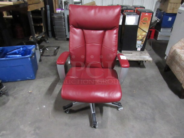 One Red Pleather Office Chair On Casters.