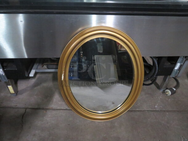 One 19X24  Framed Oval Mirror.