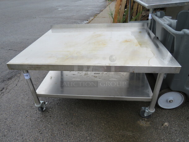 One Stainless Steel Equipment Table With Under Shelf On Casters. 47X35X24