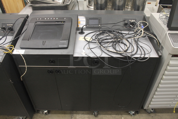Crestron Commercial Black Sound And Media System Work Station With Monitor And 3 Door Storage Cabinets Along With Extron, Ashly, Magnavox And Crestron Equipment Including Magnavox VHS Player On Commercial Casters. 