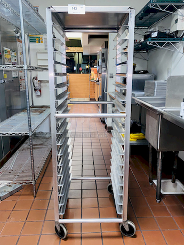 ALMOST PERFECT! Lockwood RA64-ER18ES Intermediate Height 18 Level 64" End Load Rack.
Condition: 8/10 
A hard working, versatile line of racks
Construction: High tensile extruded aluminum
Dimensions: 64"H x 21 3/8"W x 26 1/2"D
Tray supports: 1-1/2″ wide extruded pan supports riveted to uprights
Center Spacing: 3"
Pan Capacity: (18) 18" x 26" pans
Casters: 5" non-marking swivel threaded stem
Actual Weight: 45 lbs. - Image 5 of 6