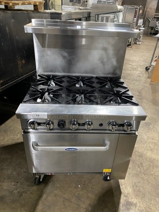 Cook Rite Commercial Natural Gas Powered 6 Burner Stove! With Raised Back Splash And Salamander Shelf! With Oven Underneath! Metal Oven Rack! All Stainless Steel! Model: AGR6B SN: AGR6BAUS100320062400C40001! Working When Removed!