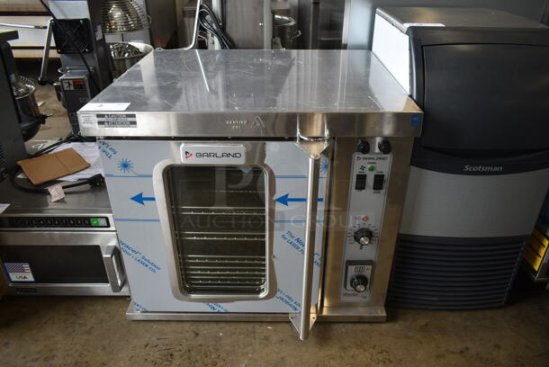 BRAND NEW SCRATCH AND DENT! 2022 Garland MCO-E-5-C Stainless Steel Commercial Electric Powered Half Size Convection Oven w/ View Through Door, Metal Oven Racks and Thermostatic Controls. 208 Volts, 3 Phase. 