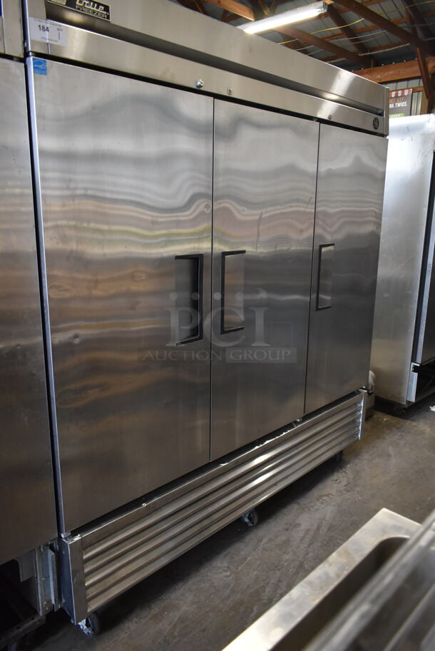 2015 True T-72F ENERGY STAR Stainless Steel Commercial 3 Door Reach In Freezer w/ Poly Coated Racks on Commercial Casters. 115 Volts, 1 Phase. Tested and Working! - Image 1 of 9