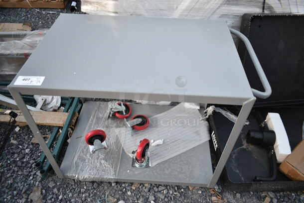 BRAND NEW SCRATCH AND DENT! Lavex Gray Metal 2 Tier Cart w/ Commercial Casters.  - Image 1 of 6