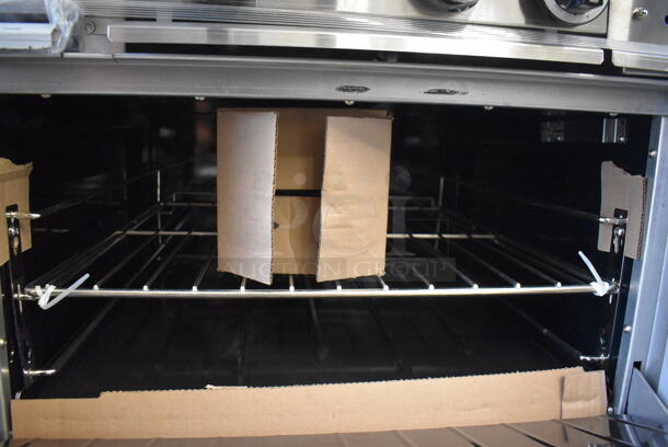 BRAND NEW SCRATCH AND DENT! Garland G60-6G24RR Stainless Steel Commercial Natural Gas Powered 6 Burner Range w/ Right Side Flat Top Griddle, 2 Ovens, Over Shelf and Back Splash. Missing 1 Leg and 1 Leg Is Bent. 310,000 BTU. 59x34x59. Tested and Working! - Image 9 of 11