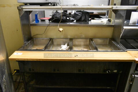 Metal Commercial Electric Powered 4 Well Steam Table w/ Over Shelf and Under Shelf. This Unit Was In Working Condition When the Restaurant Closed. (kitchen)