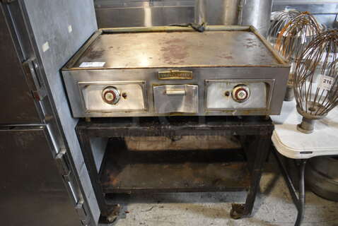 Toastmaster Stainless Steel Commercial Countertop Electric Powered Flat Top Griddle on Metal Equipment Stand w/ Commercial Casters. 208 Volts, 1 Phase. 36x24x42.5