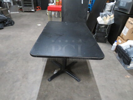 One Black Laminate Table Top On A Pedestal Base. 48X30X29