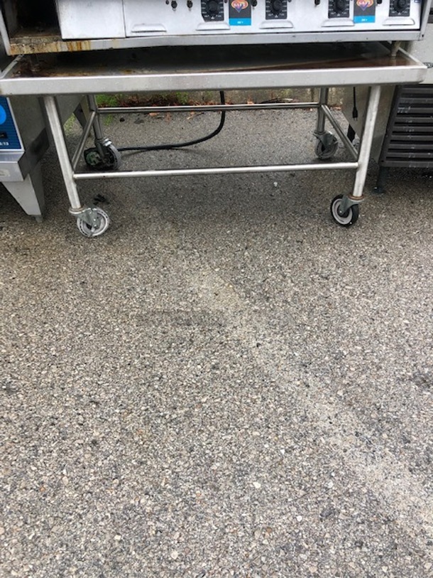 One Stainless Steel Equipment Table On Casters. 49X39X24
