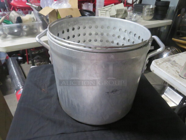 One 12X12 Aluminum Stock Pot With Steamer Basket. 