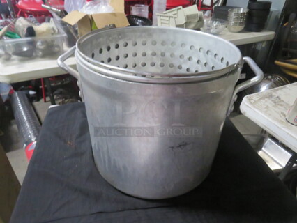 One 12X12 Aluminum Stock Pot With Steamer Basket. 
