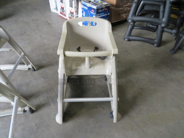 One Beige Poly High Chair With Safety Straps, On Casters.