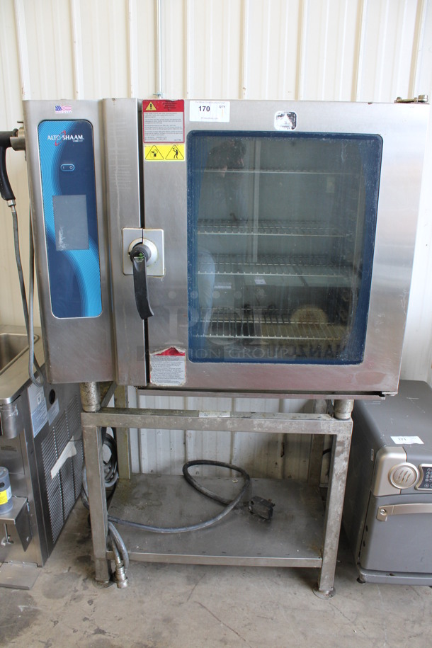 2013 Alto Shaam Model 10.10 ESI Stainless Steel Commercial Electric Powered Combitherm Convection Oven w/ View Through Door and Metal Oven Racks on Stainless Steel Equipment Stand. 208-240 Volts, 3 Phase. 46x34x67