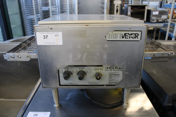 Star Holman Model 214HX Stainless Steel Commercial Countertop Electric Powered Conveyor Pizza Oven. Missing 1 Leg. 208 Volts, 1 Phase. 31x18x16