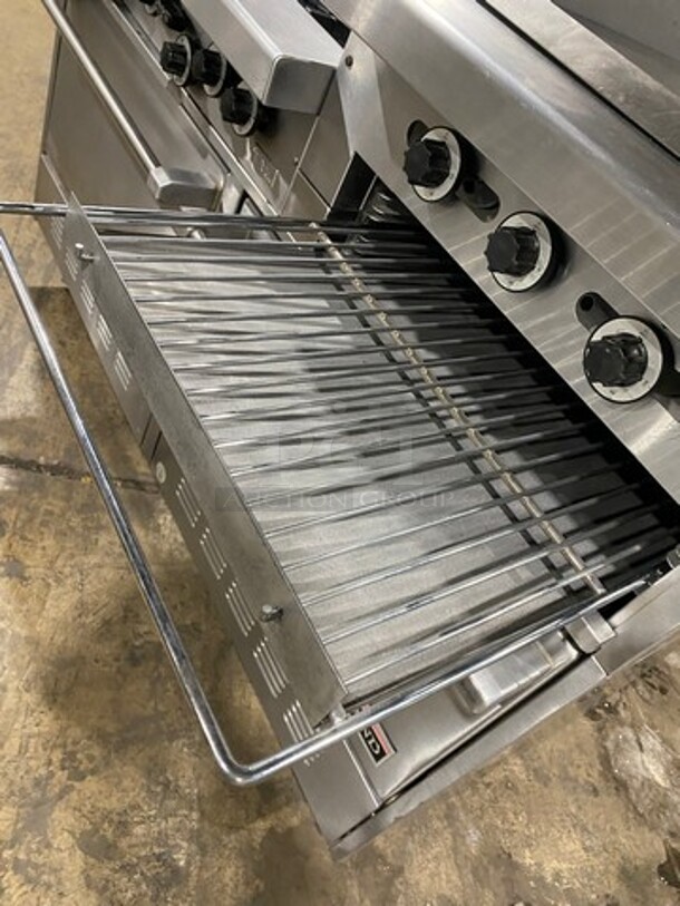 GREAT FIND! Garland Commercial Gas Powered 6 Burner Stove With Right Side Flat Griddle! Griddle Has Side Splashes! With Raised Back Splash And Salamander Shelf! With 2 Oven Underneath! Metal Oven Racks! All Stainless Steel! On Casters! - Image 10 of 11