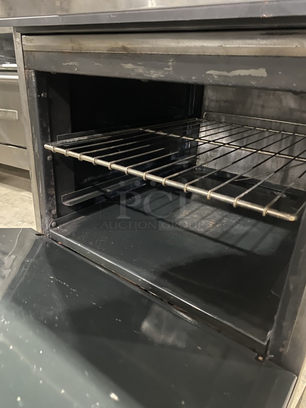 American Range Commercial Natural Gas Powered 4 Burner Stove! With Raised Back Splash! With Full Size Oven Underneath! All Stainless Steel! On Legs!
 - Image 7 of 8