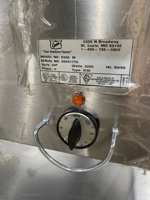 NEW! NEVER USED! Duke Commercial Electric Powered 3 Well Steam Table! With Storage Space Underneath! With Commercial Cutting Board! All Stainless Steel! On Casters! Model: E303M SN: 03041770! 208V 3 Phase! - Image 8 of 9