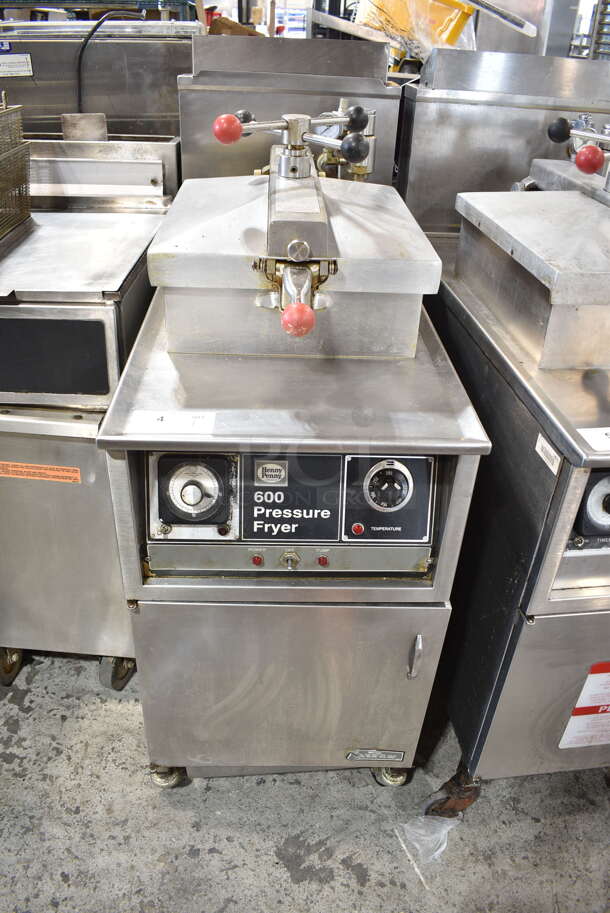 Henny Penny 600 Stainless Steel Commercial Floor Style Natural Gas Powered Pressure Fryer w/ Metal Fry Basket on Commercial Casters. 80,000 BTU.  - Image 1 of 10