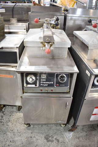 Henny Penny 600 Stainless Steel Commercial Floor Style Natural Gas Powered Pressure Fryer w/ Metal Fry Basket on Commercial Casters. 80,000 BTU. 
