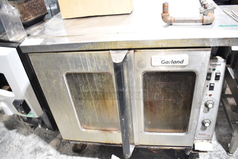 Garland Master 200 Stainless Steel Commercial Natural Gas Powered Full Size Convection Oven w/ View Through Doors and Thermostatic Controls on Commercial Casters. 