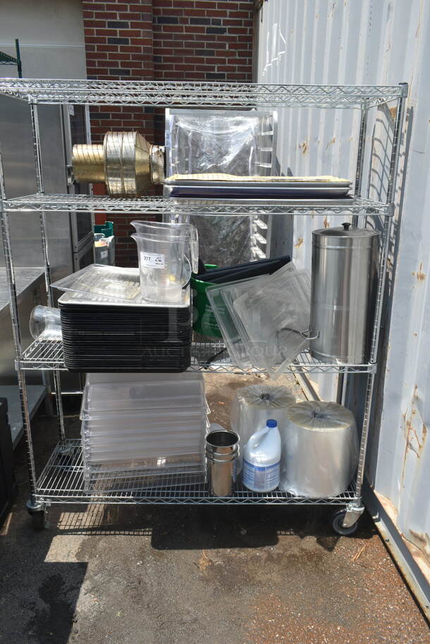 Chrome Finish 4 Tier Wire Shelving Unit w/ Contents Including Trays and Poly Bins on Commercial Casters. BUYER MUST DISMANTLE. PCI CANNOT DISMANTLE FOR SHIPPING. PLEASE CONSIDER FREIGHT CHARGES. - Image 1 of 5