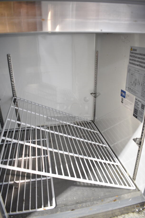 BRAND NEW SCRATCH AND DENT! 2023 Avantco 178APPT91HC Stainless Steel Commercial Pizza Prep Table. Comes w/ Commercial Casters. 115 Volts, 1 Phase. Tested and Does Not Power On - Image 6 of 9
