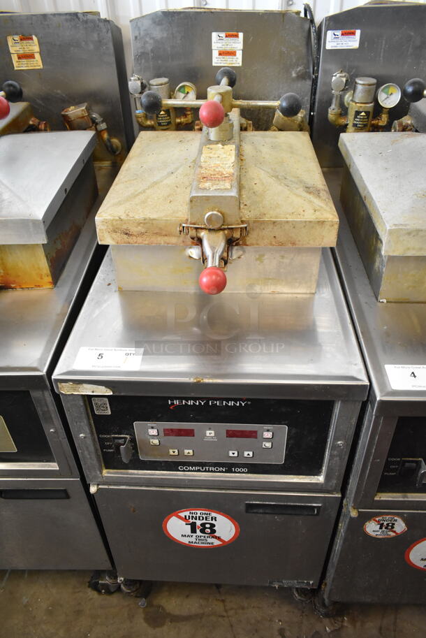 Henny Penny 600 Stainless Steel Commercial Floor Style Natural Gas Powered Pressure Fryer w/ Metal Fry Basket on Commercial Casters. 80,000 BTU.