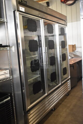 True T-72G Stainless Steel Commercial 3 Door Reach In Cooler Merchandiser w/ Poly Coated Racks on Commercial Casters. 115 Volts, 1 Phase. Tested and Working!
