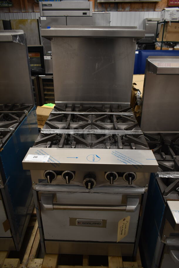 BRAND NEW SCRATCH AND DENT! 2022 Garland G24-4L Stainless Steel Commercial Natural Gas Powered 4 Burner Range w/ Oven, Over Shelf and Back Splash. 