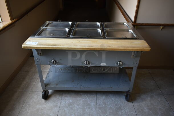 Stainless Steel Commercial 3 Well Steam Table w/ Butcher Block Cutting Board and Under Shelf on Commercial Casters. Tested and Does Not Power On. (front hallway) - Image 1 of 7