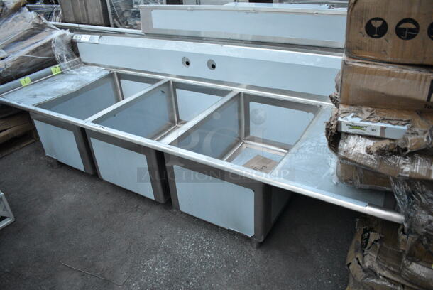 BRAND NEW SCRATCH AND DENT! Regency 600S32030220 Stainless Steel Commercial 3 Bay Sink w/ Dual Drain Boards. Bays 20x30. Drain Boards 18.5x32.  - Image 1 of 8