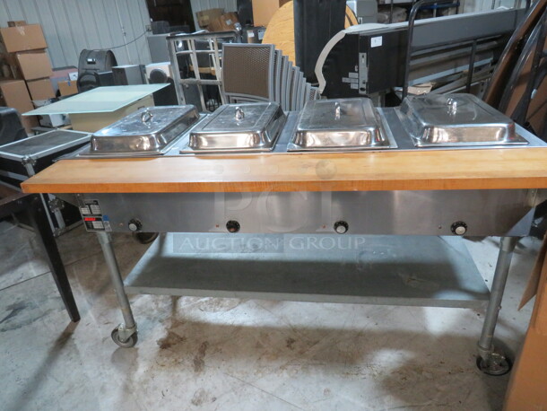 One Eagle 4 Well Steam Table With Under Shelf, Butcher Block Rail, And 4 Lids, On Casters. Model# DHT4-240. 240 Volt. 1 Phase. 3000 Watt. 64X31X38.5 - Image 1 of 3