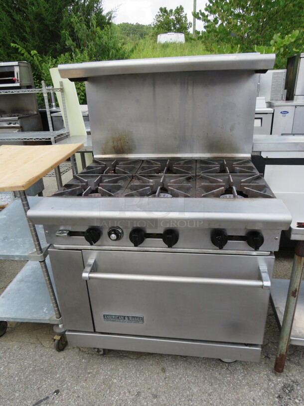 One Natural Gas American Range 6 Burner With Over Shelf, And 2 Racks, On Casters. 36X32X57 - Image 1 of 2