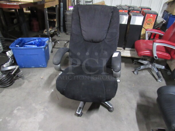 One Black Cushioned  Office Chair On Casters.