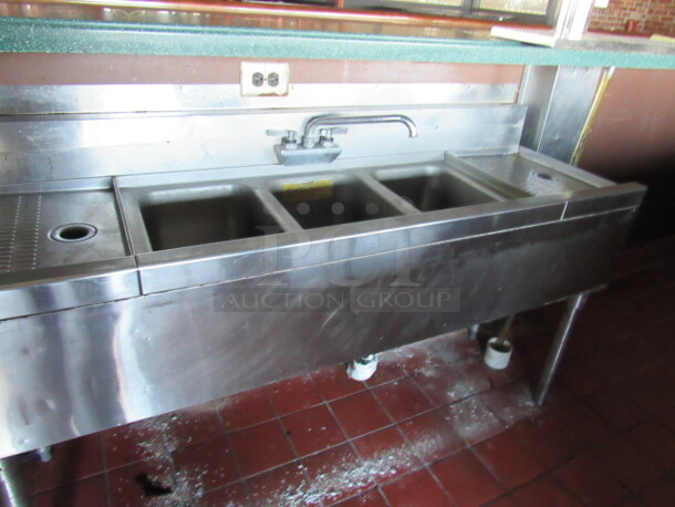 One Stainless Steel 3 Compartment Under Bar Sink With Faucet And R/L Drain Board. 60X20X32. BUYER MUST REMOVE