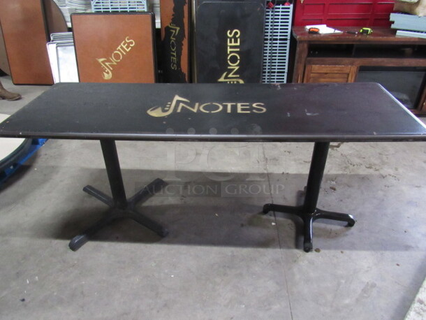 One Black Table Top With The NOTES Logo On Dual Pedestal Bases. 72X24X30