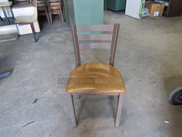 One Brown Metal Chair With Brown Cushioned Seat. 