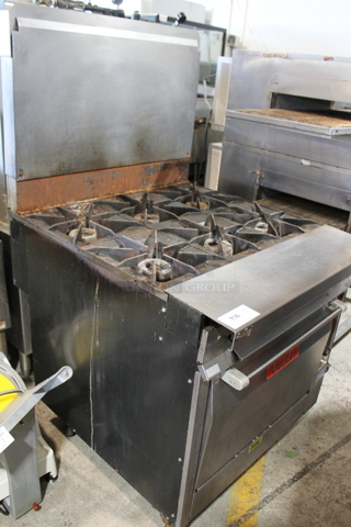 Vulcan Stainless Steel Commercial Gas Powered 6 Burner Range w/ Oven and Back Splash. 