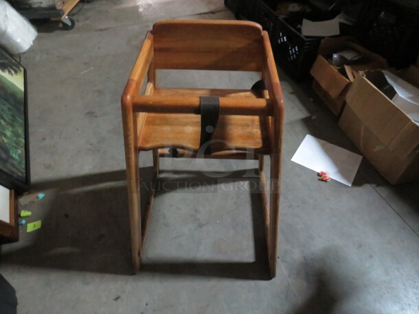 One Wooden High Chair With Safety Straps.