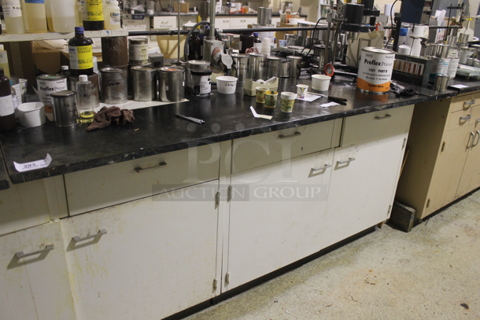 White Counter w/ Black Countertop, Doors, Drawers and Contents. BUYER MUST REMOVE.