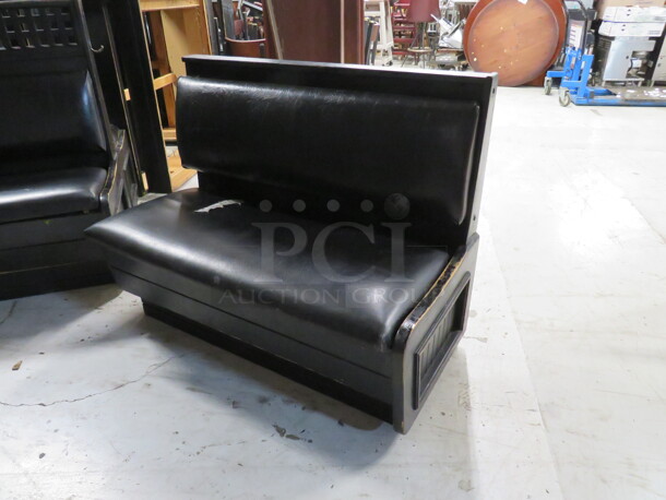 One Black Wooden Single Sided Booth With Black Cushioned Seat And Back. 45X24X36