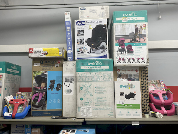 MASSIVE LOT! (3) Little Tikes 2-In-1 Snug & Secure Swings – 1 Blue, 2 Pink; (17) Nuby Water Resistant Baby Bibs (assorted colors); (1) Graco “Caden Fashion” Comfy Cruiser™ Travel System With Snugride® 30; (1) Allen YOOGO CZ2 Convertible Cargo Trailer → Handy Pull Cart,  (1) Delta Children Sweet Slumber Bassinet, (1) Chicco LullaGo Portable Bassinet, (1) Chicco NextFit Sport Convertible Car Seat, (2) Evenflo Omni Plus Modular Travel System – Includes LITEMAX Rear-Facing Infant Car Seat, (1) Baby Trend EZ Ride Girl 35 - Includes NEW 4-35 Ibs Infant Car Seat , (1) Evenflo Nurture Infant Car Seat Base. 11x Your Bid - Image 1 of 12