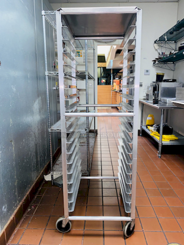 ALMOST PERFECT! Lockwood RA64-ER18ES Intermediate Height 18 Level 64" End Load Rack.
Condition: 8/10 
A hard working, versatile line of racks
Construction: High tensile extruded aluminum
Dimensions: 64"H x 21 3/8"W x 26 1/2"D
Tray supports: 1-1/2″ wide extruded pan supports riveted to uprights
Center Spacing: 3"
Pan Capacity: (18) 18" x 26" pans
Casters: 5" non-marking swivel threaded stem
Actual Weight: 45 lbs. - Image 3 of 6